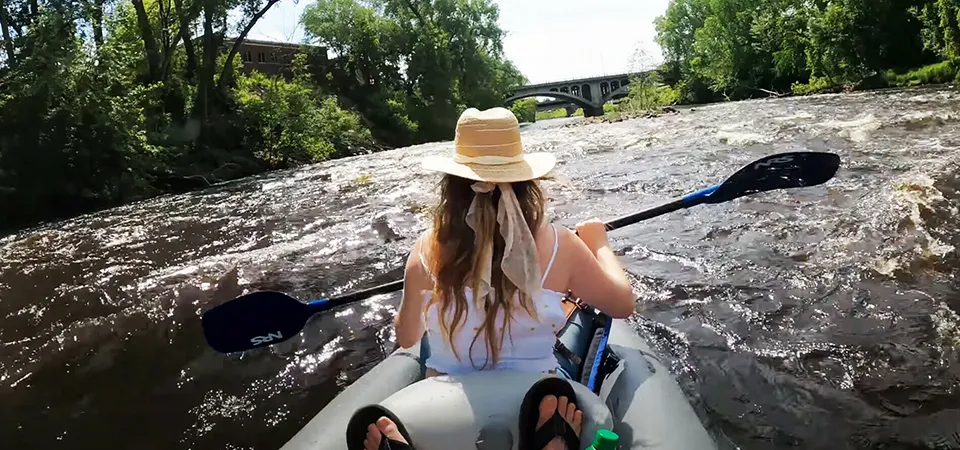 Back view of a girl enjoying a thrilling kayak ride in Zimbabwe